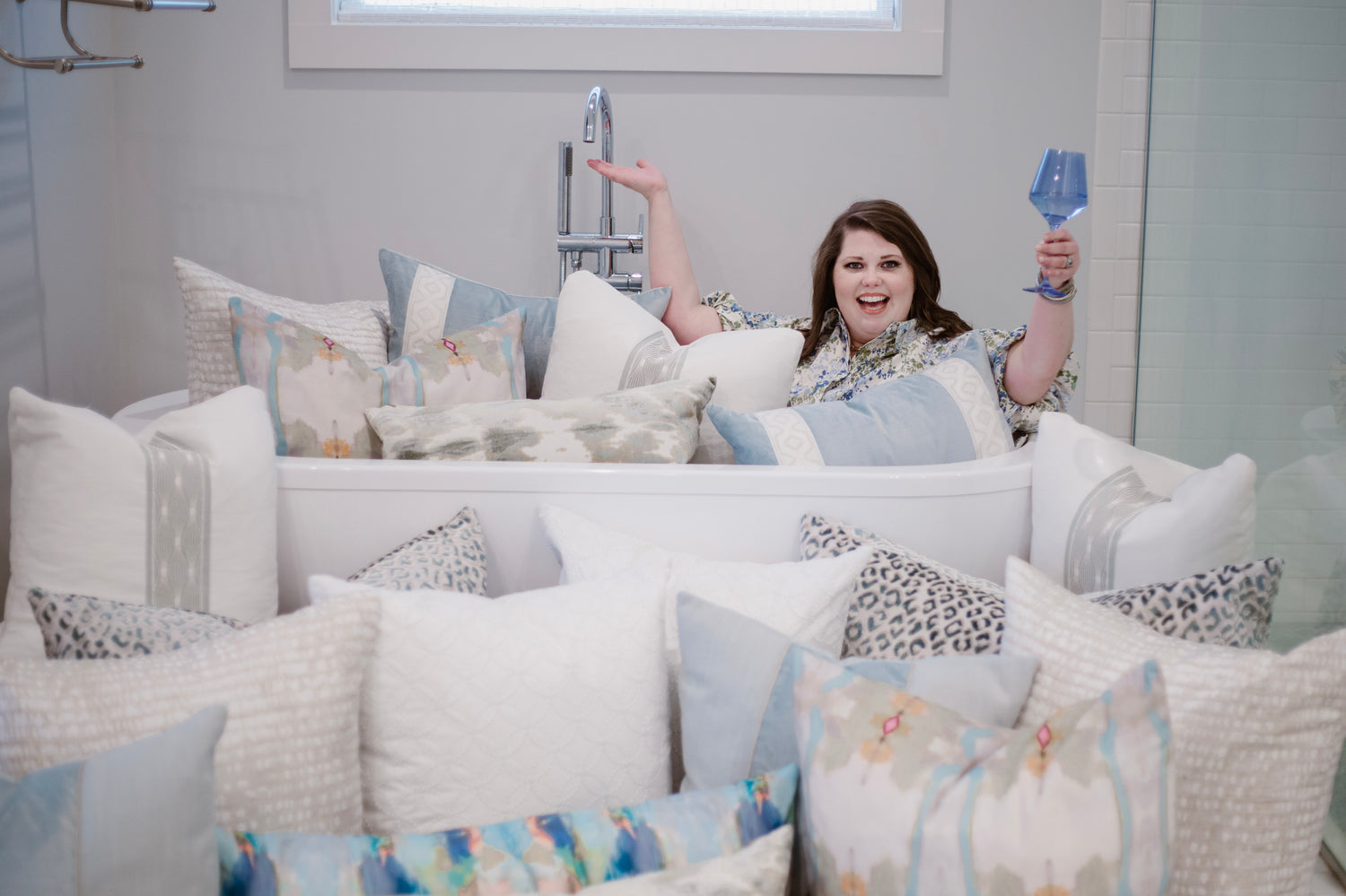 interior design by Lauren Egger, woman in bathtub with custom pillows