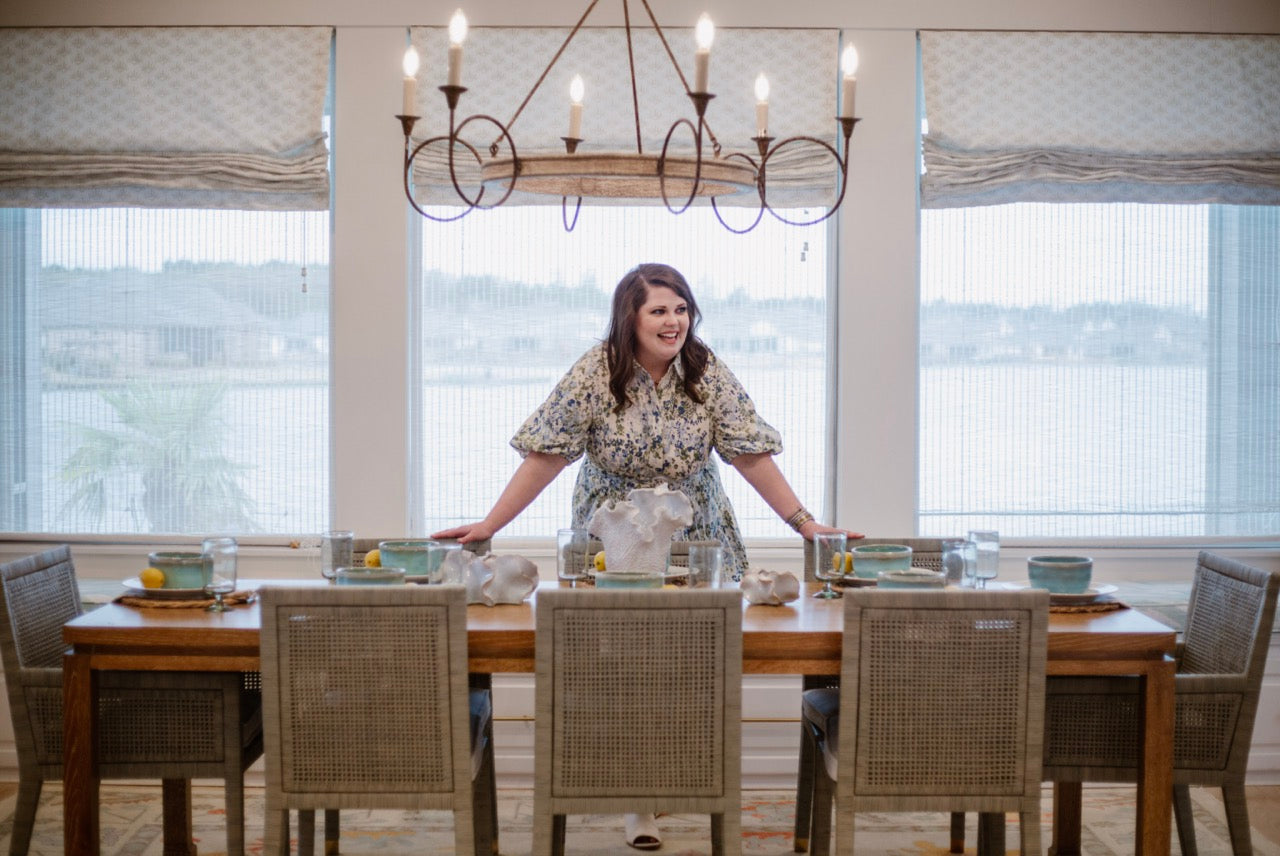 dining room interior design with wooden table, rattan chairs, blue hues, by Lauren Egger Designs