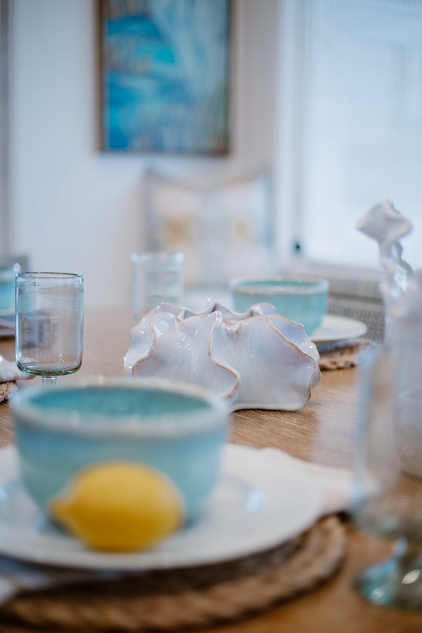 Beach themed interior design table setting with Seashell bowl focal point