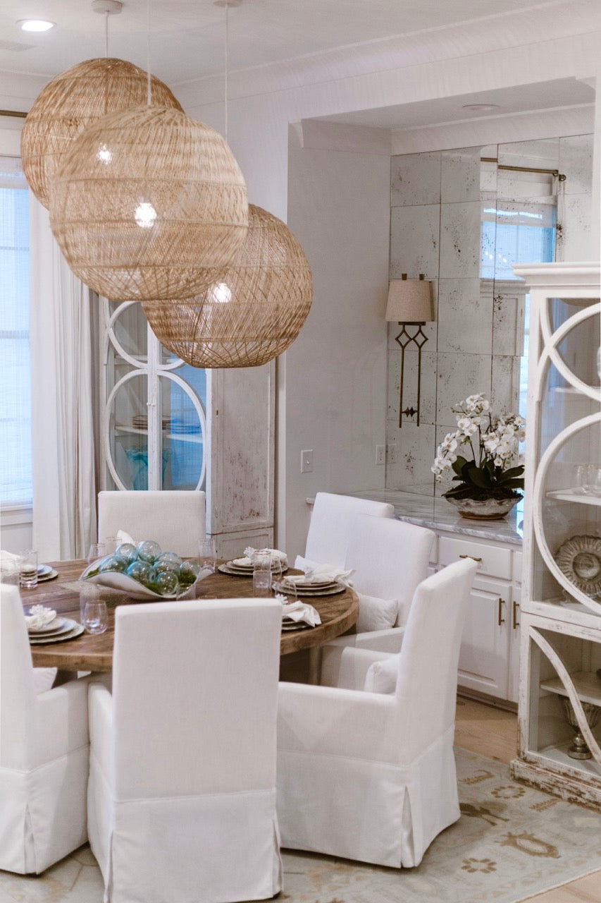 brown table with white fabric chairs, interior design by Lauren Egger Designs