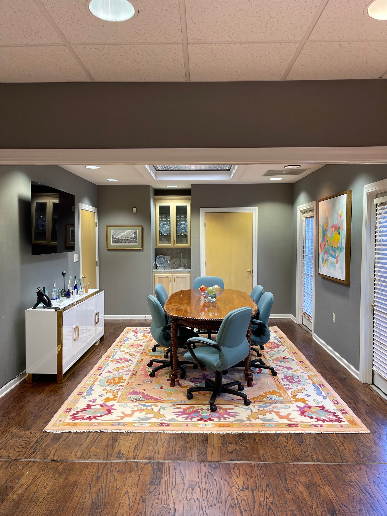 interior design of an office with custom rug and blue chairs by Lauren Egger Designs